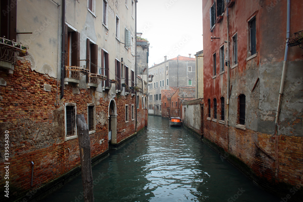 Scenic canals and bridges of foggy Venice, Italy