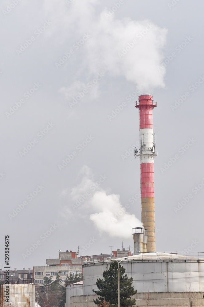 Dirty grey smoke from smokestack in the city. Smoke from district heating Dirty grey smoke from smokestack in the city. Smoke from district heating