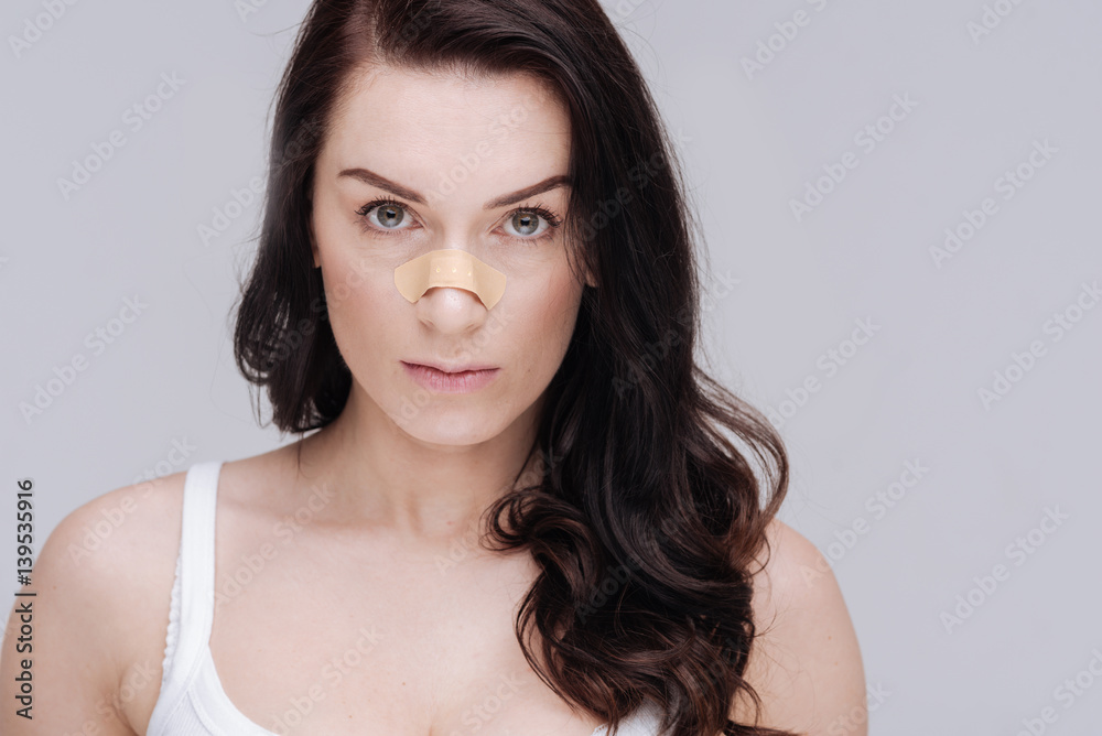 Stunning young woman posing with a patch on her face Stunning young woman posing with a patch on her face