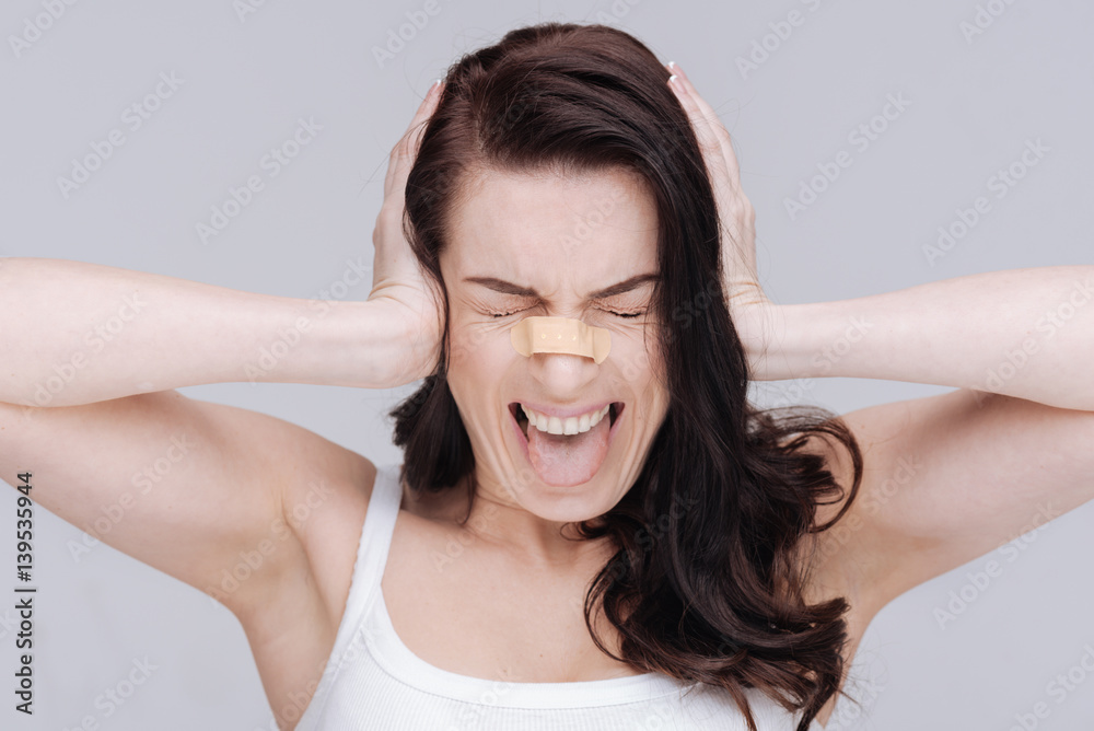 Emotional young lady overwhelmed with criticism Emotional young lady overwhelmed with criticism