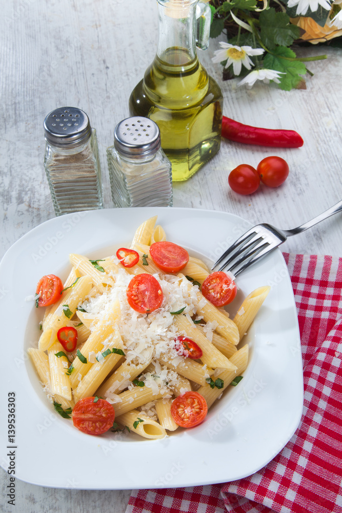 Pasta with cherry tomatoes, chili pepper and basil