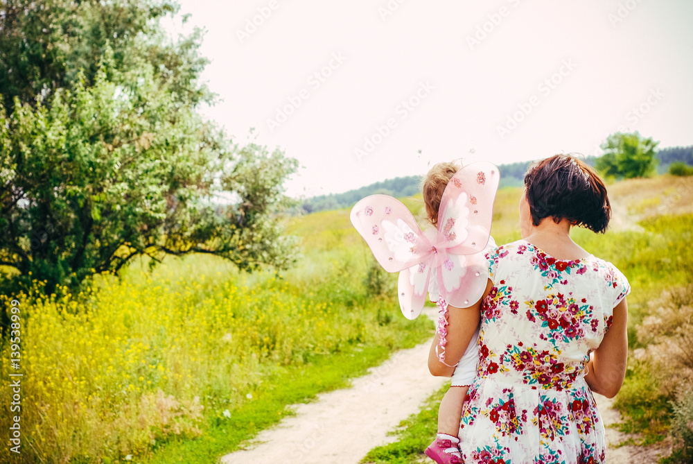 concept of family. mother and child daughter outdoors in summer concept of family. mother and child daughter outdoors in summer