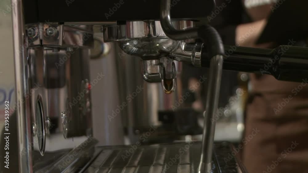 Making coffee in electric coffe machine in a cafe Making coffee in electric coffe machine in a cafe