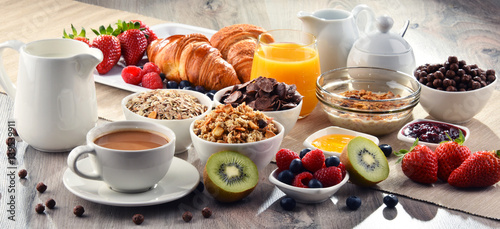 Breakfast served with coffee  juice  croissants and fruits