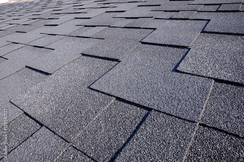 Close up view on Asphalt Roofing Shingles Background. Roof Shingles - Roofing.