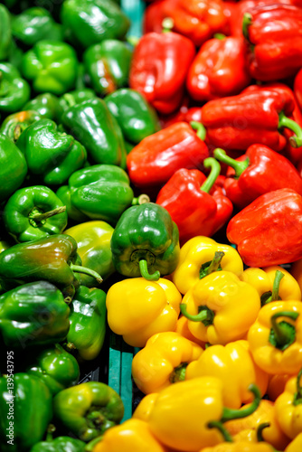 Ripe Yellow, Red and Green Peppers in Vegetables Market