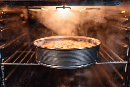 'close up view of homemade cake in oven photo