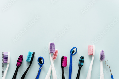 colourful toothbrushes on blue background photo