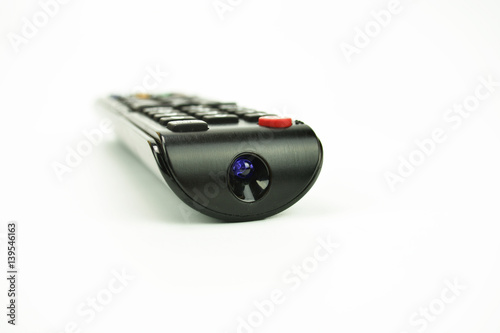 A black remote control on the white background