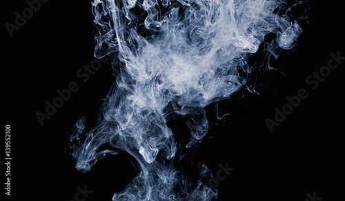 Abstract pattern of white smoke on a black background. Waves of mist and clouds.