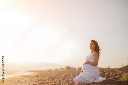 Wallpaper Mural Young pregnant woman walking on the beach  Torontodigital.ca