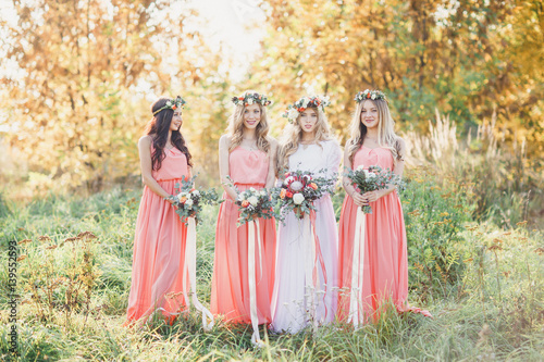 Bride with bridesmaids in pink dresses. A wedding in the summer.