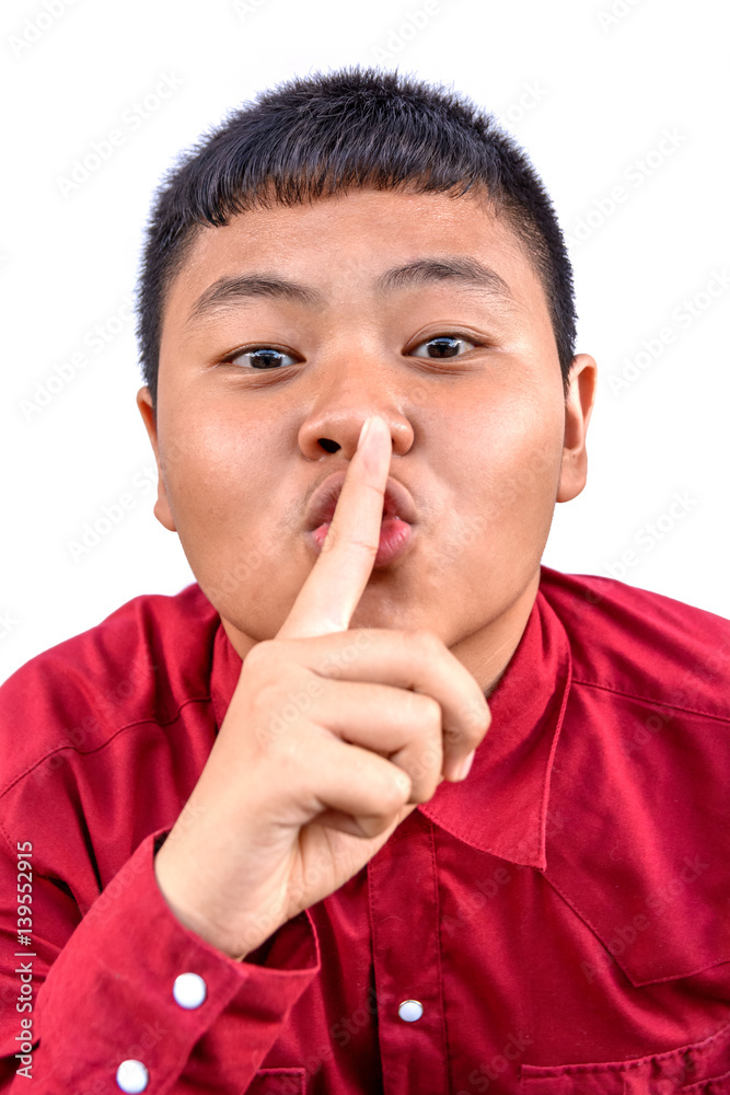 funny portrait of one Asia boy on the white background. The boy says you should be quite. funny portrait of one Asia boy on the white background. The boy says you should be quite.
