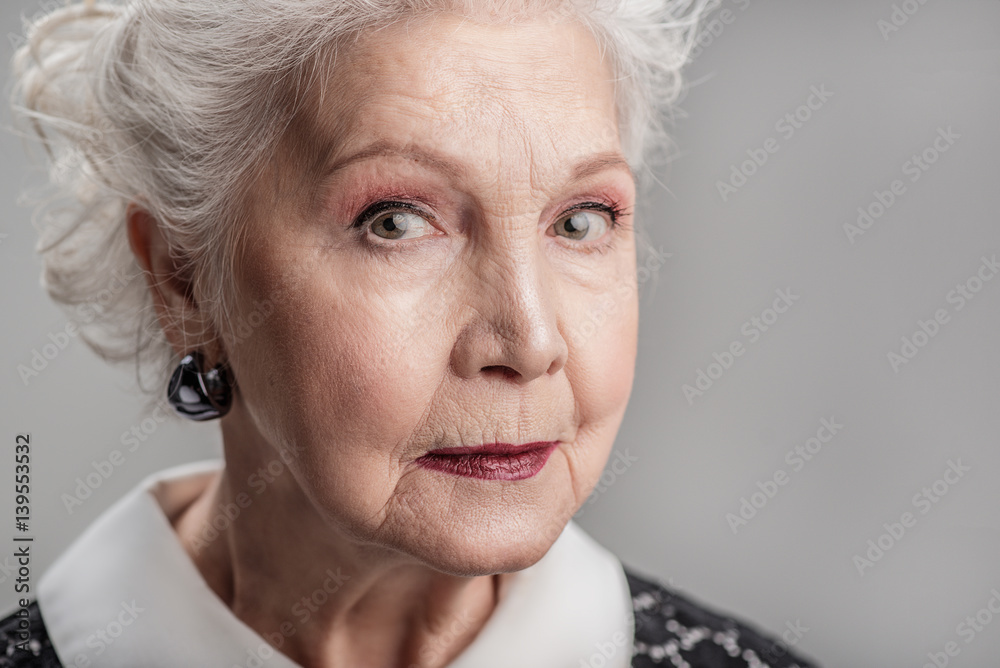 Senior woman looking forward pensively Senior woman looking forward pensively