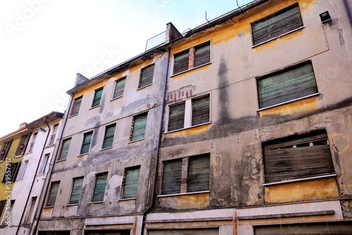 Old and damaged  facade of uninhabited building.