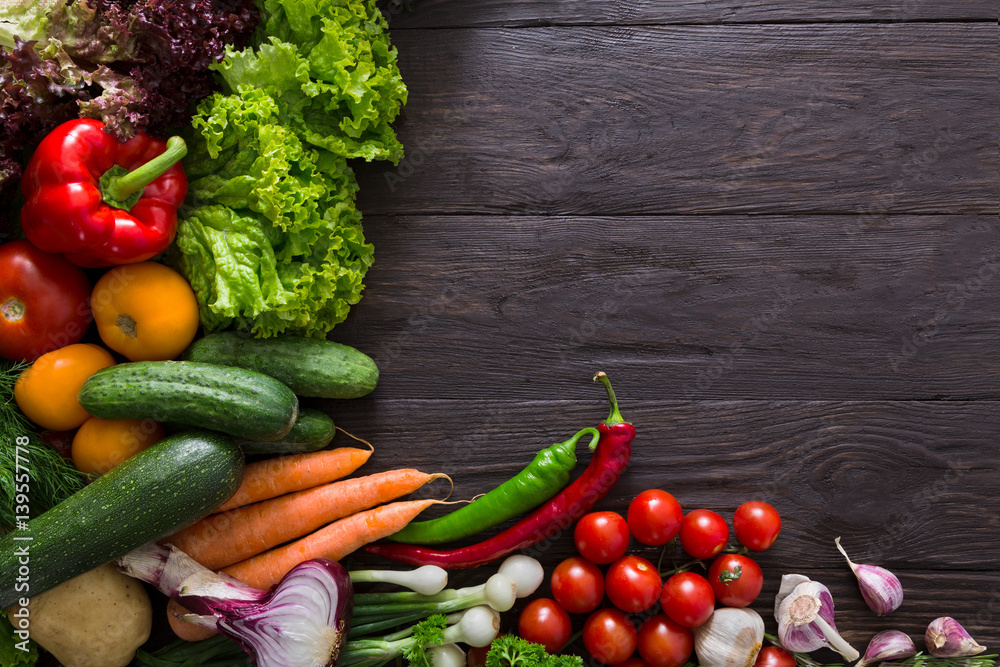 Border of fresh vegetables on wooden background with copy space Border of fresh vegetables on wooden background with copy space