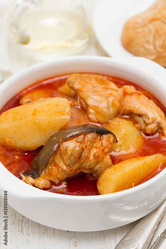 fish stew on white bowl on wooden background fish stew on white bowl on wooden background