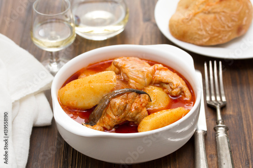 fish stew on white bowl on wooden background