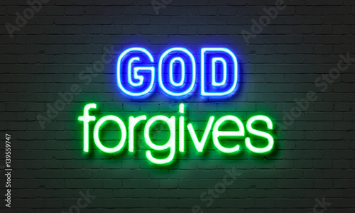 God forgives neon sign on brick wall background.
