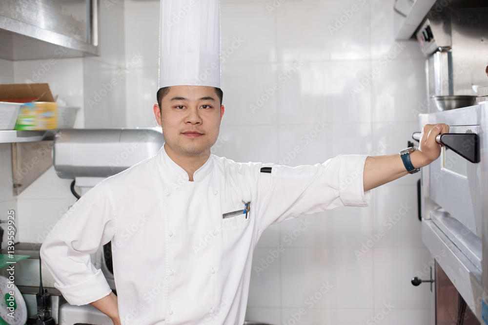 young man chelf in modern kitchen young man chelf in modern kitchen