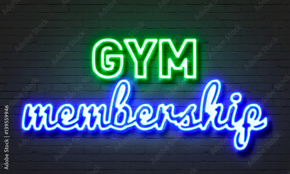 Gym membership neon sign on brick wall background.