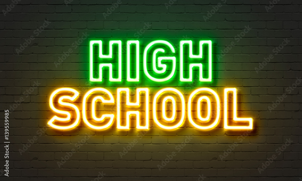 Obraz premium High school neon sign on brick wall background.