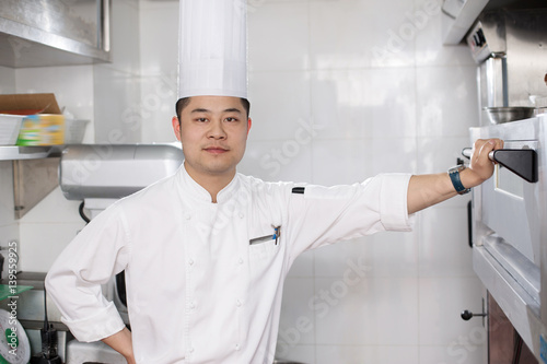 young man chelf in modern kitchen