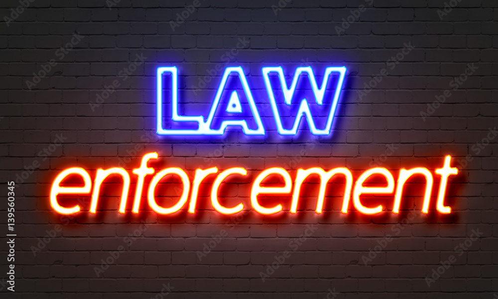 Law enforcement neon sign on brick wall background. Law enforcement neon sign on brick wall background.