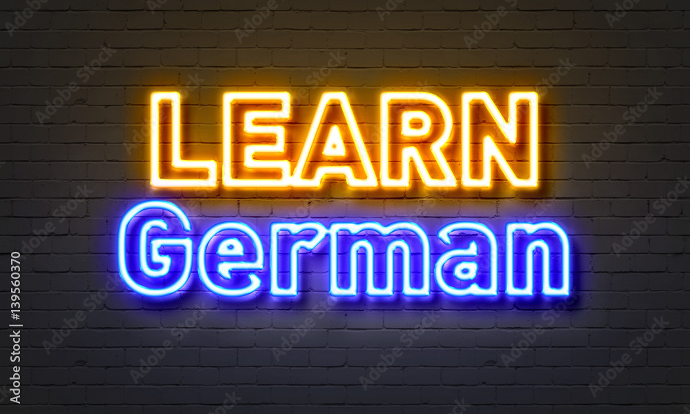 Learn German neon sign on brick wall background. Learn German neon sign on brick wall background.