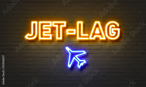 Jet-lag neon sign on brick wall background.
