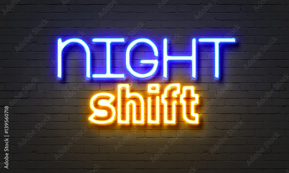 Night shift neon sign on brick wall background. Night shift neon sign on brick wall background.