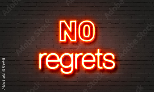 No regrets neon sign on brick wall background.