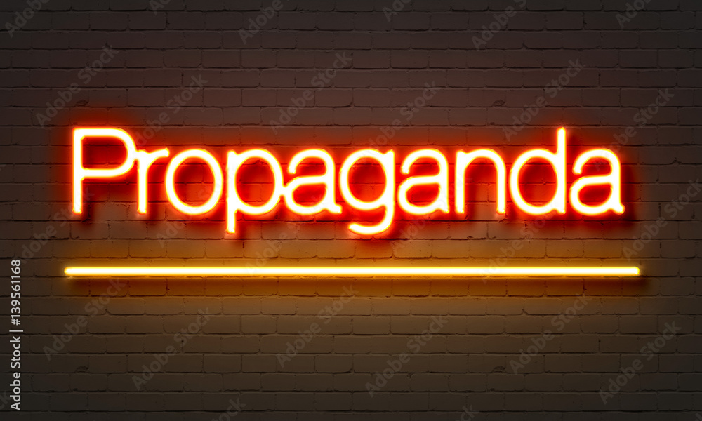 Propaganda neon sign on brick wall background. Propaganda neon sign on brick wall background.