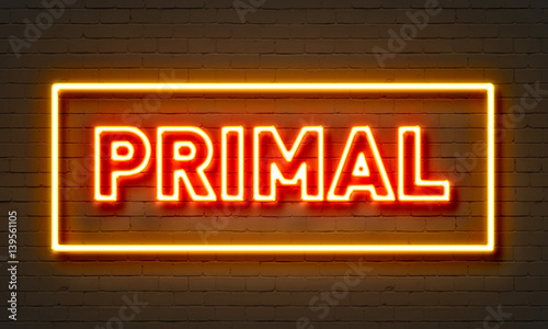 Primal neon sign on brick wall background. photo