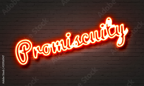 Promiscuity neon sign on brick wall background. photo