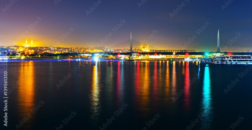 Night view of the Gold Horn Metro bridge. Panorama of the two shores of the Bosphorus Strait. Istanbul bridge at night Turkey