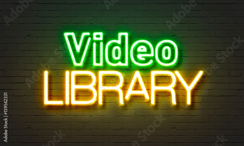 фотографія Video library  neon sign on brick wall background.