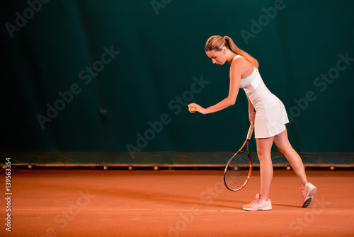 Indoor tennis court playing athlete. © nazarovsergey
