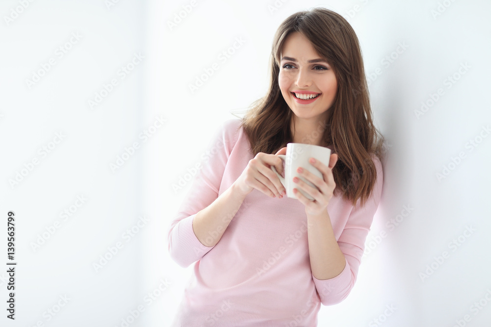 Laughing beautiful woman with cup of coffee on white background Laughing beautiful woman with cup of coffee on white background
