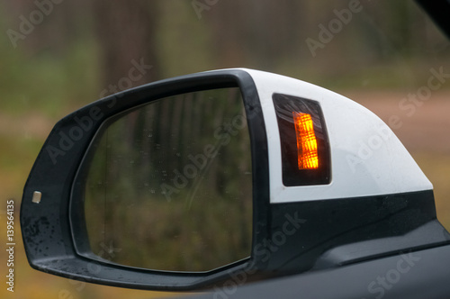 Left side rear view mirror with blind spot indicator.