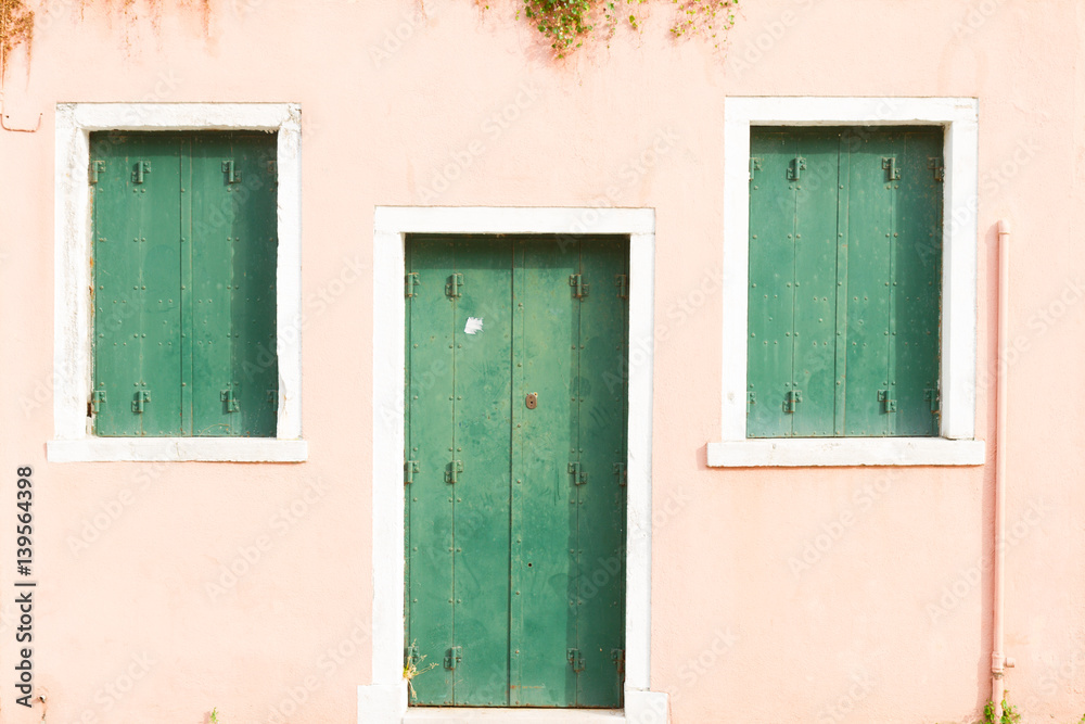 bright pink typical house facade of Burano island, Venice, Italy bright pink typical house facade of Burano island, Venice, Italy