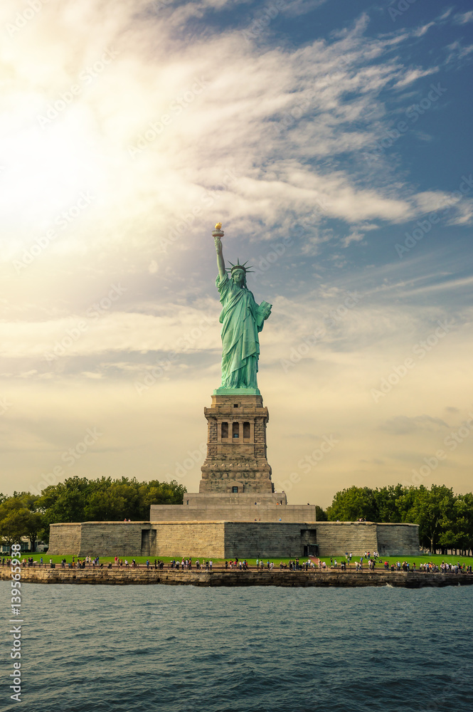 Statue of Liberty on Liberty Island with lens flare, New York City, USA
