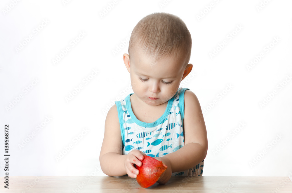 A child eating a pomegranate