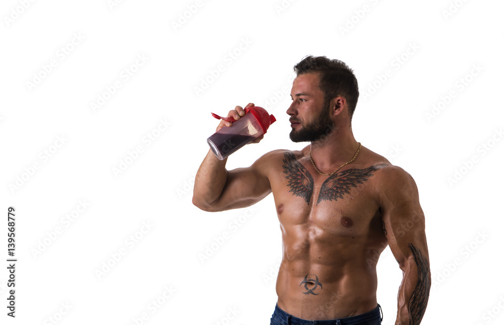 Muscular shirtless male bodybuilder drinking protein shake from blender.  Isolated on white, looking to a side Stock Photo | Adobe Stock