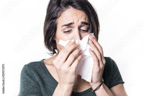 sneeze girl having flu on white studo background photo