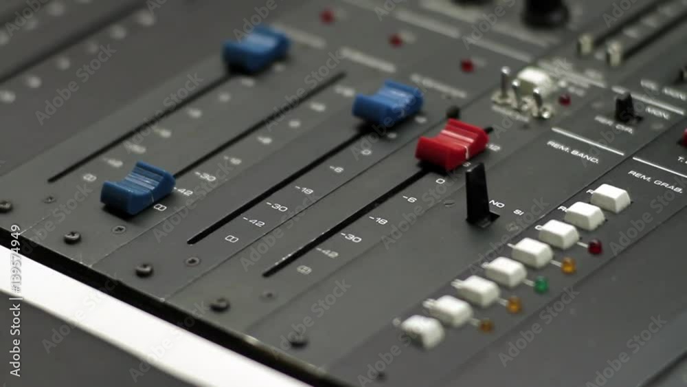 Hand Adjusting Sliders on Audio Mixing Console - Close Up Hand Adjusting Sliders on Audio Mixing Console - Close Up