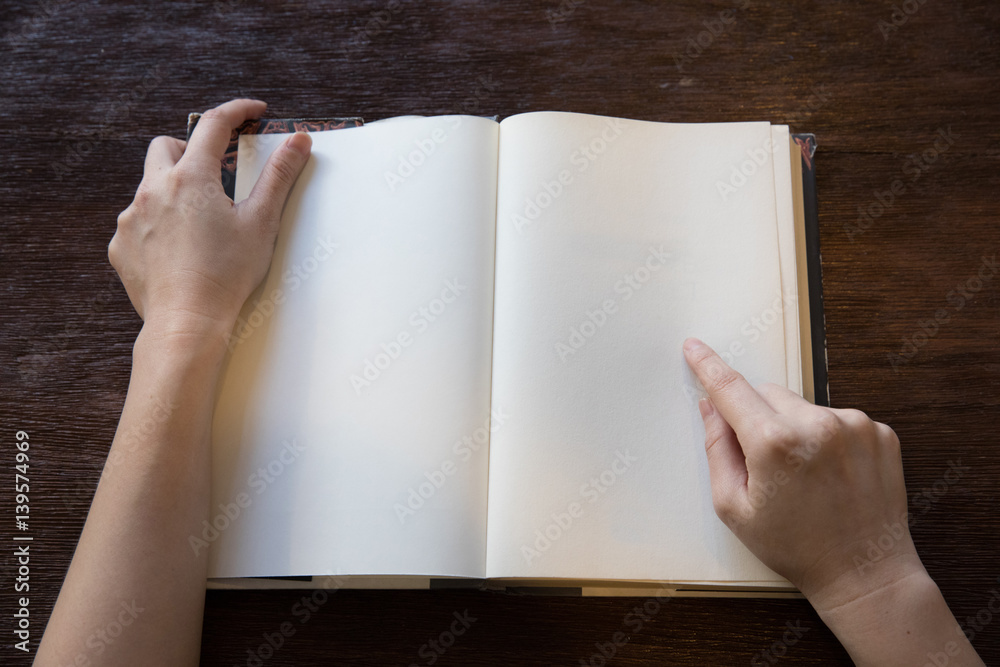woman hands point to blank space of the book woman hands point to blank space of the book