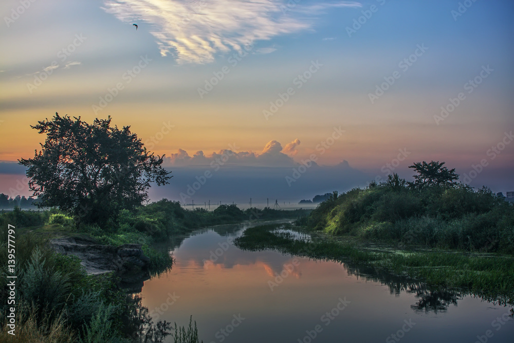 Beautiful misty dawn at the small river.