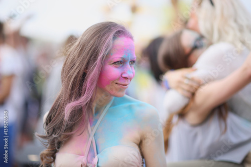 Portrait of a woman painted in the colors of Holi festival.