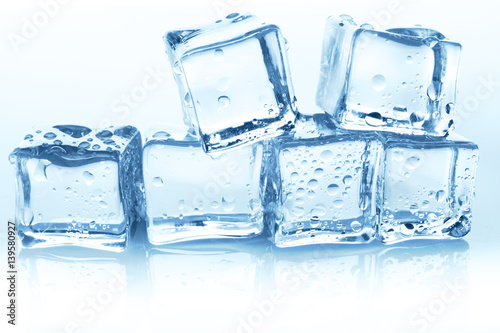 Transparent ice cubes group on white background with water drops